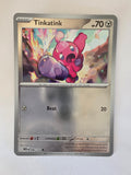 Trading card featuring a character named Tinkatink with a colorful design on a white background