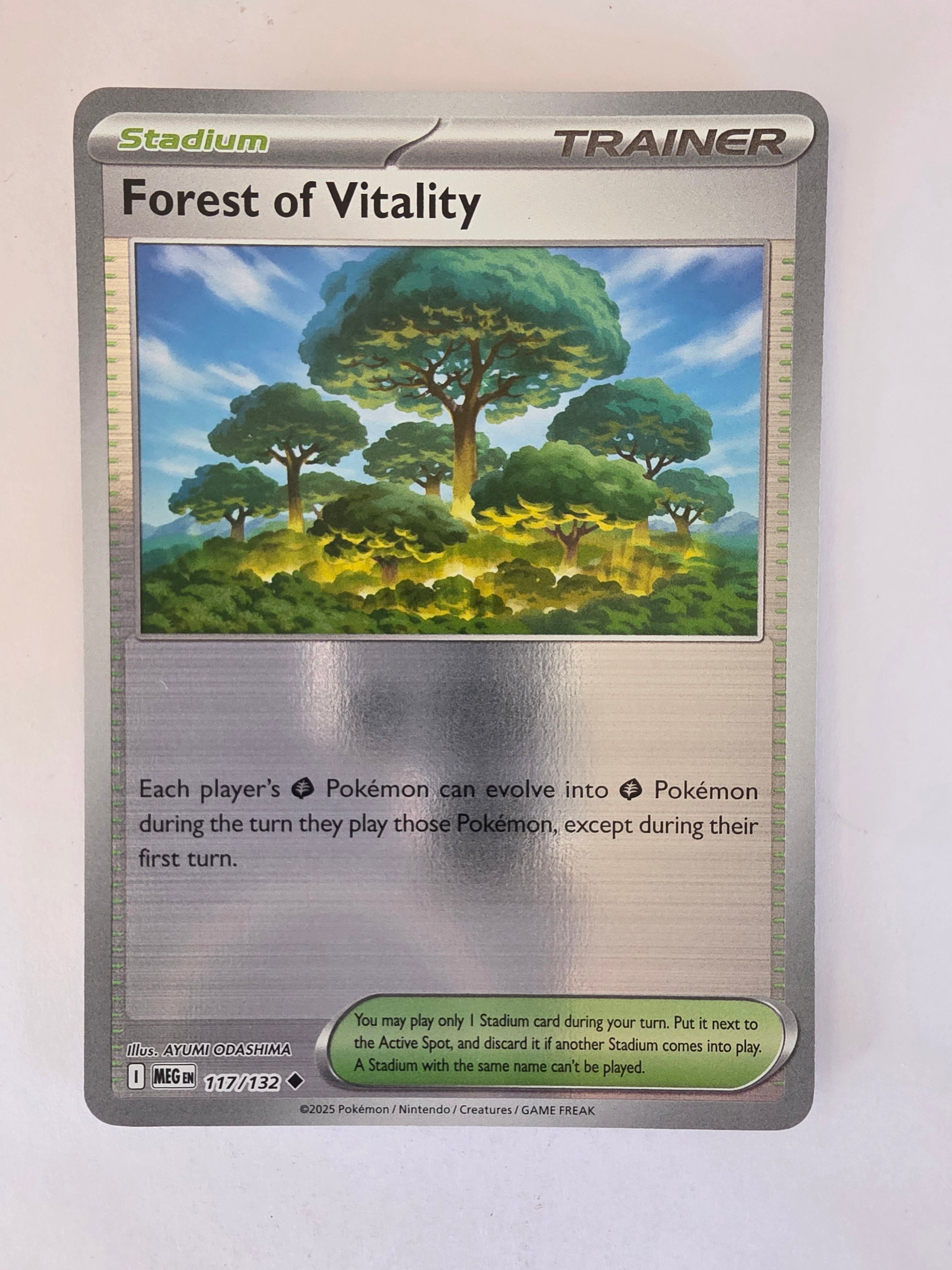 Pokémon trading card featuring a forest scene on a white background