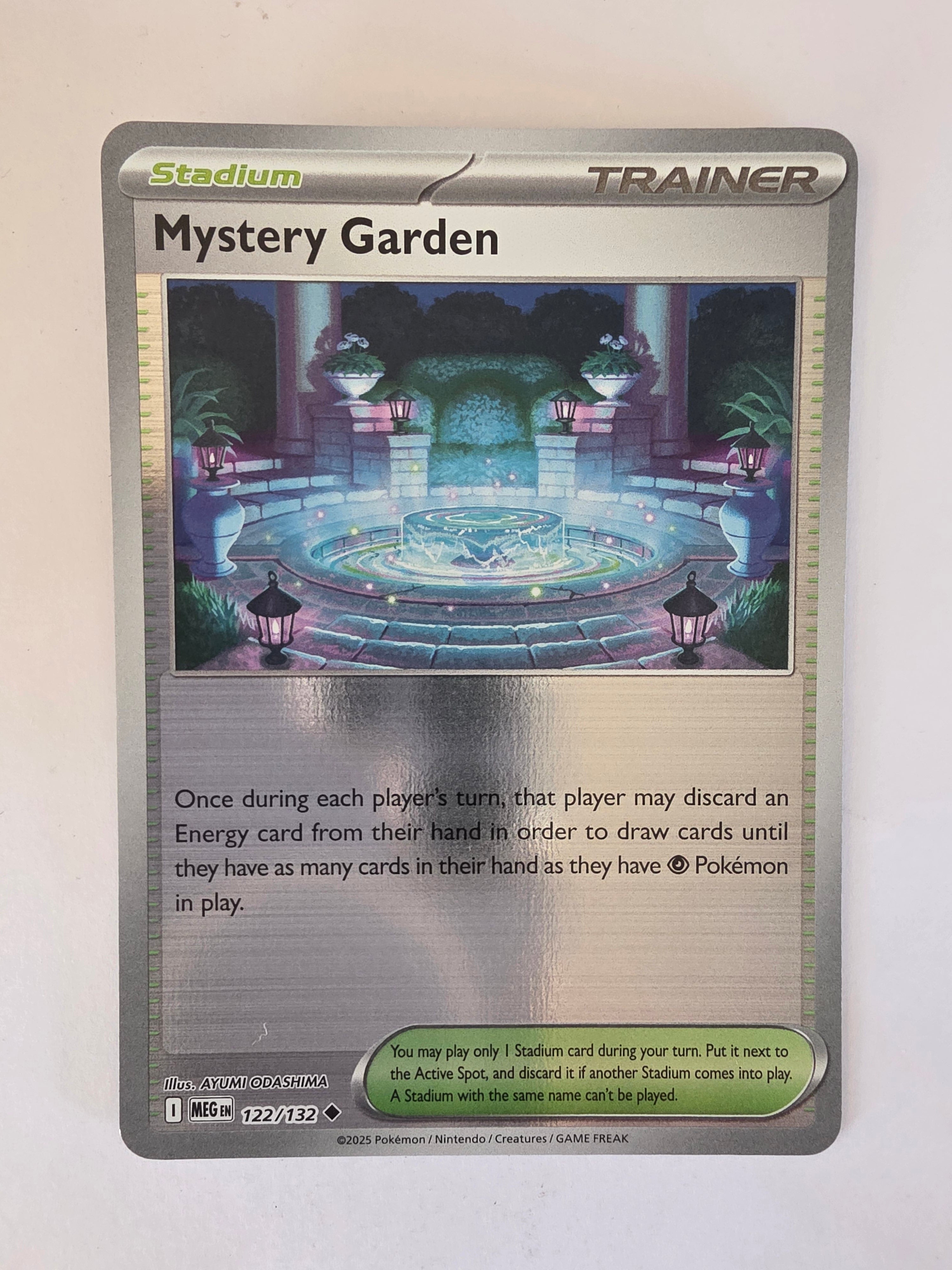 Trading card featuring a 'Mystery Garden' stadium with text on a white background