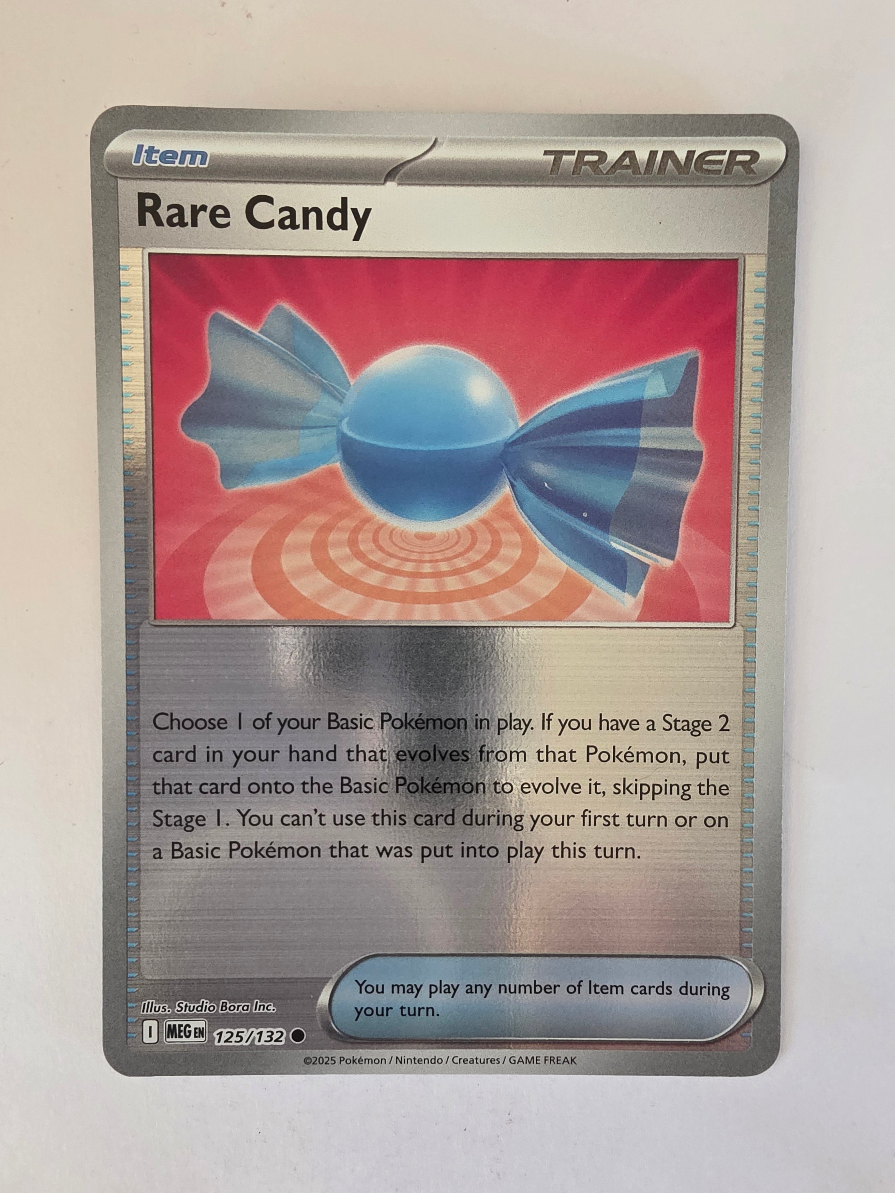 Pokémon trading card with a blue candy graphic on a red background