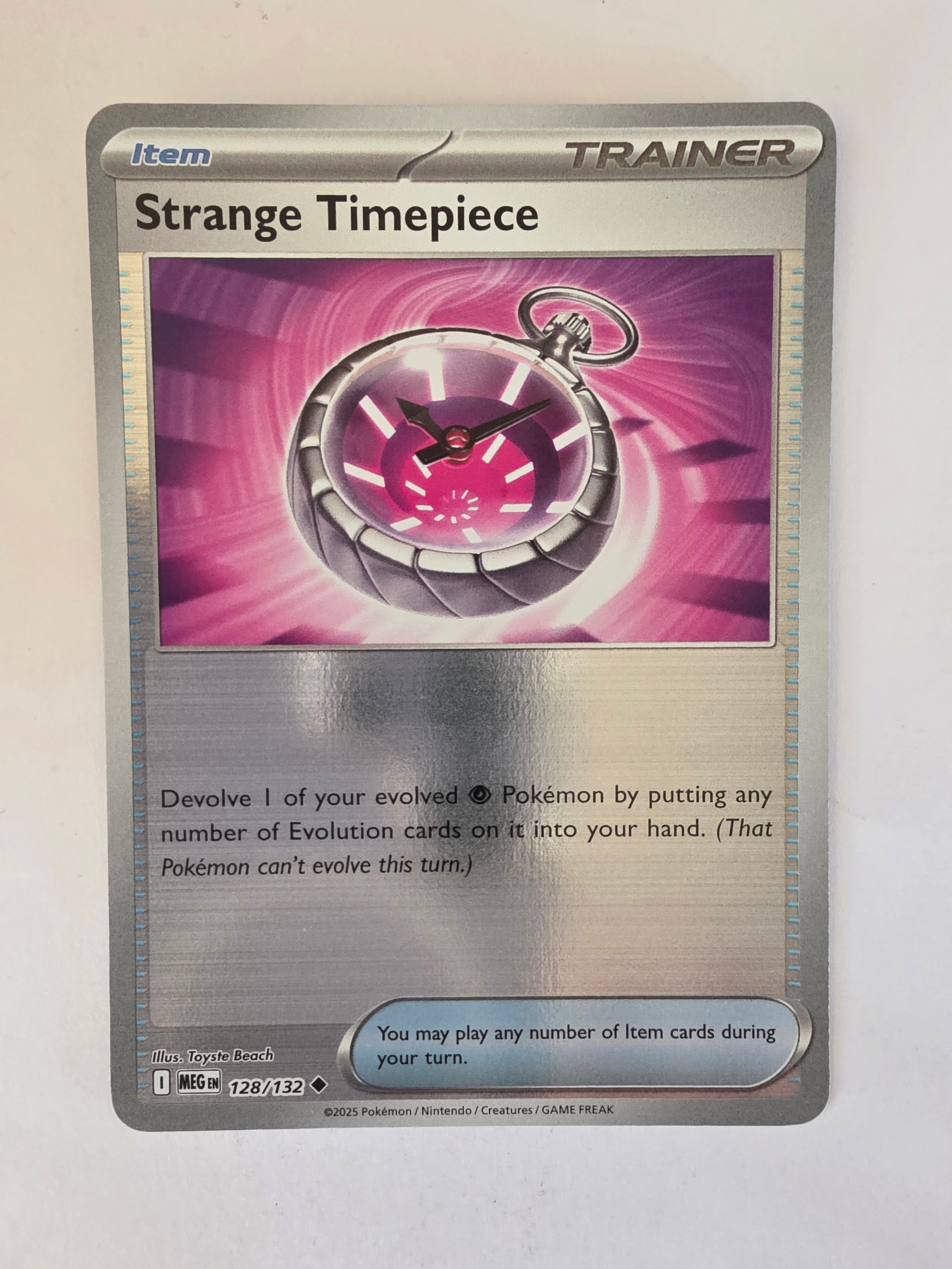 Trading card featuring a pocket watch design on a metallic background