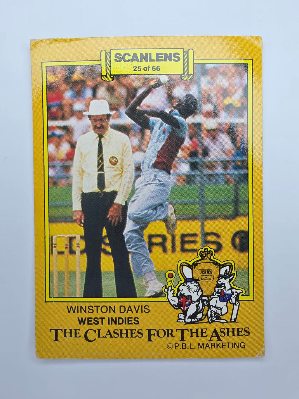 Scanlens 1986 Clashes for the Ashes cricket trading card featuring Winston Davis bowling for the West Indies.